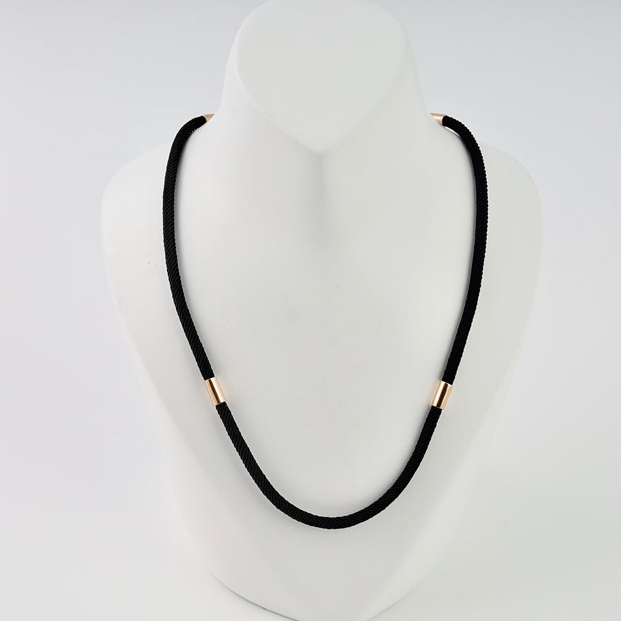 Black cord necklace with 14k gold tube accents on a display bust, minimalist chain Ukrainian Jewelry for everyday wear.