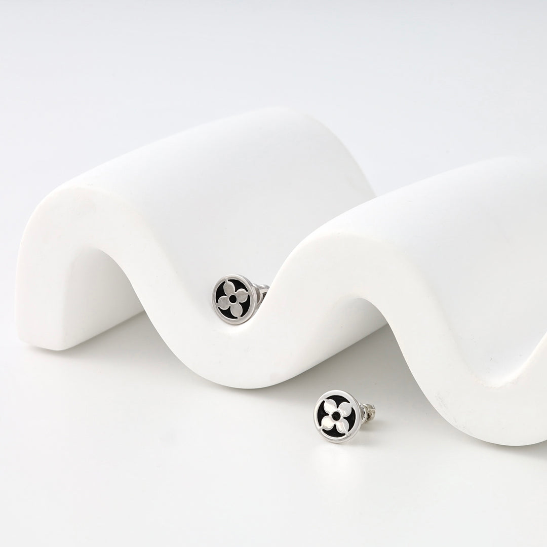 Sterling silver round stud earrings with black clover motif on white display, minimalist Ukrainian Jewelry, silver stud earrings.