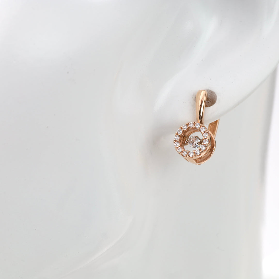 Rose gold hoop earring with clear crystals on a mannequin display.