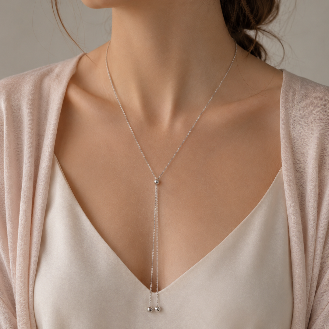 Model wearing the bolo necklace pulled long into a deep V
