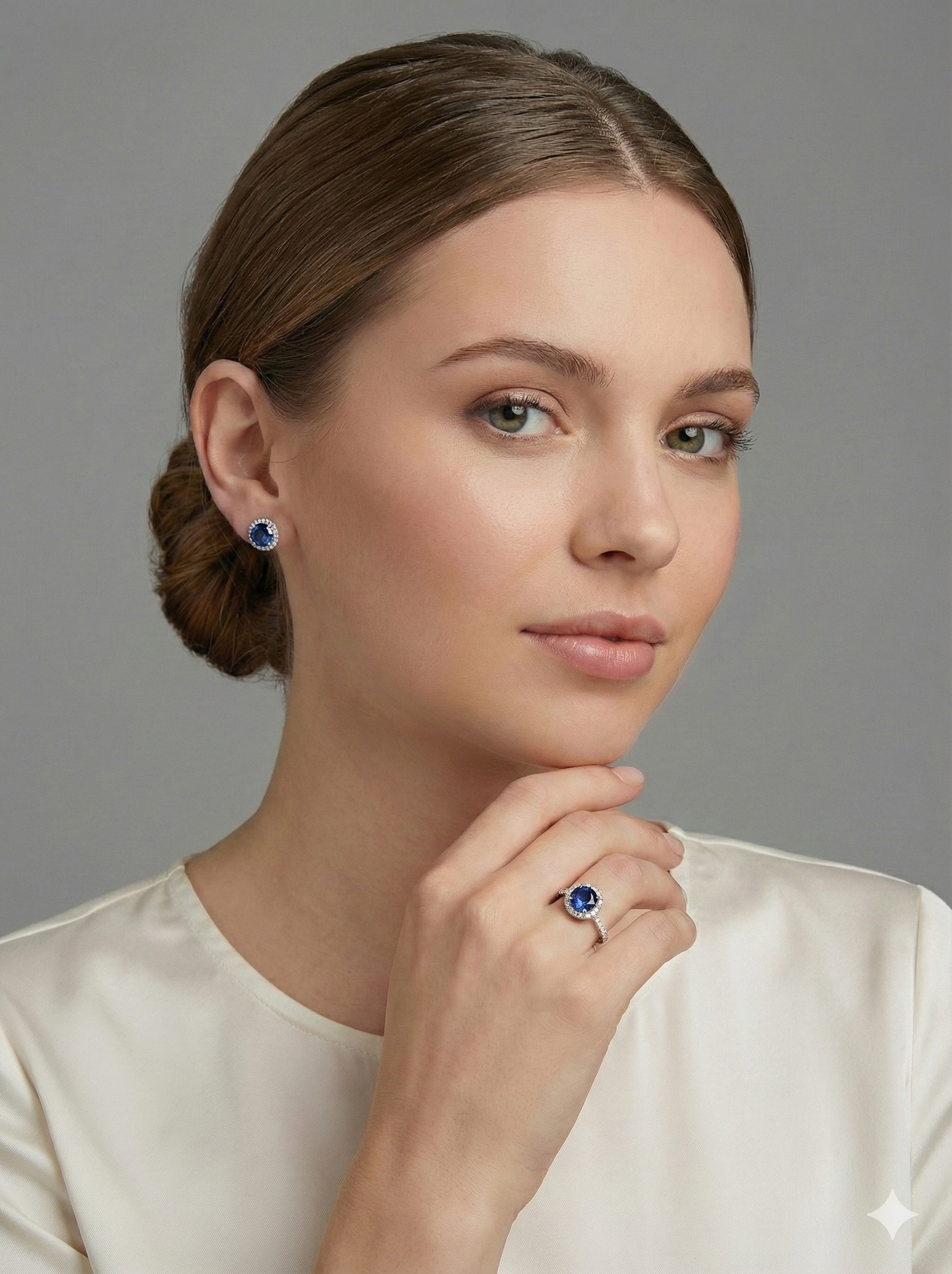 Ukrainian Jewelry model wearing sapphire 18K white gold ring and stud earrings, elegant fine jewelry portrait on grey background