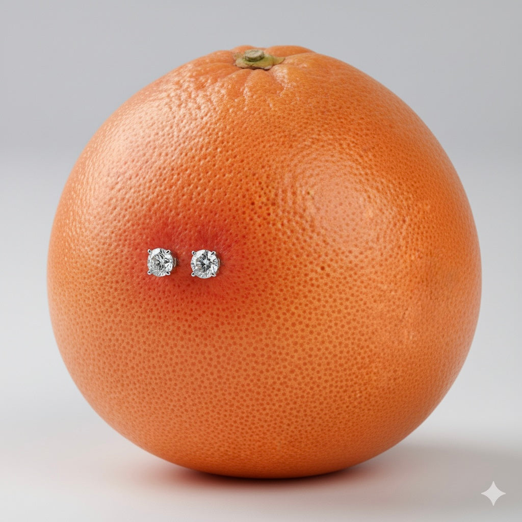 Grapefruit with diamond earrings on a gray background
