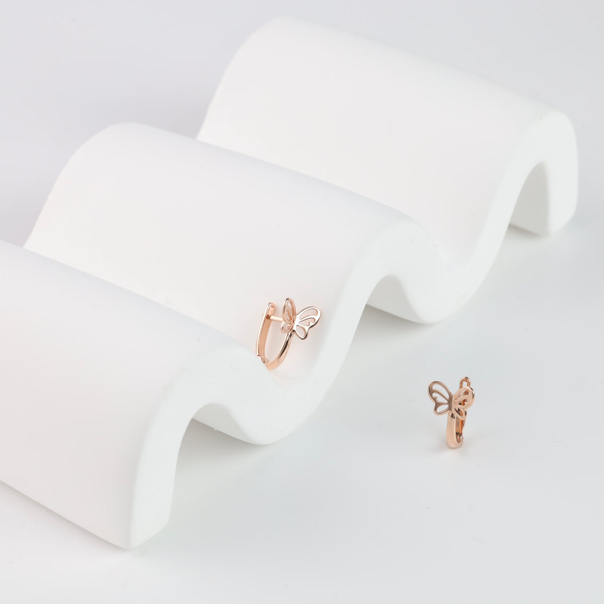 14K rose gold kids butterfly earrings with openwork wings for girls age 1–5 on a white display.