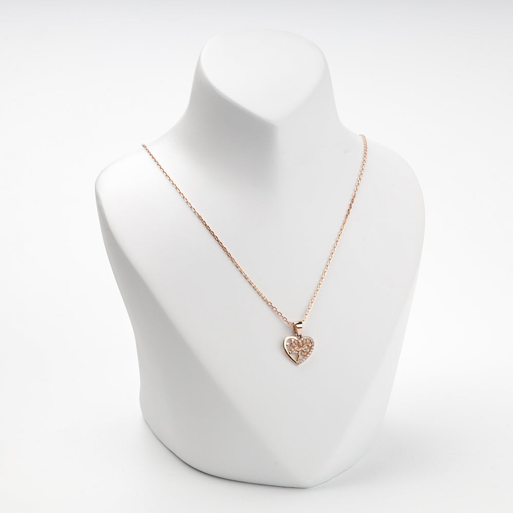 Rose gold heart tree of life pendant on display