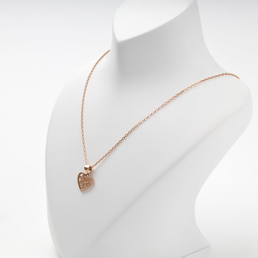 Rose gold heart tree of life pendant worn on a chain