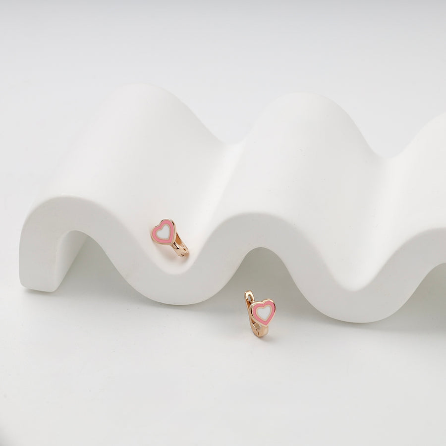 Rose gold enamel heart earrings arranged at different heights