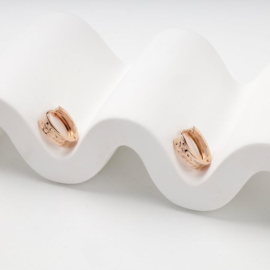 Patterned Huggie Hoop Earrings | 14K Rose Gold (585) — angled view