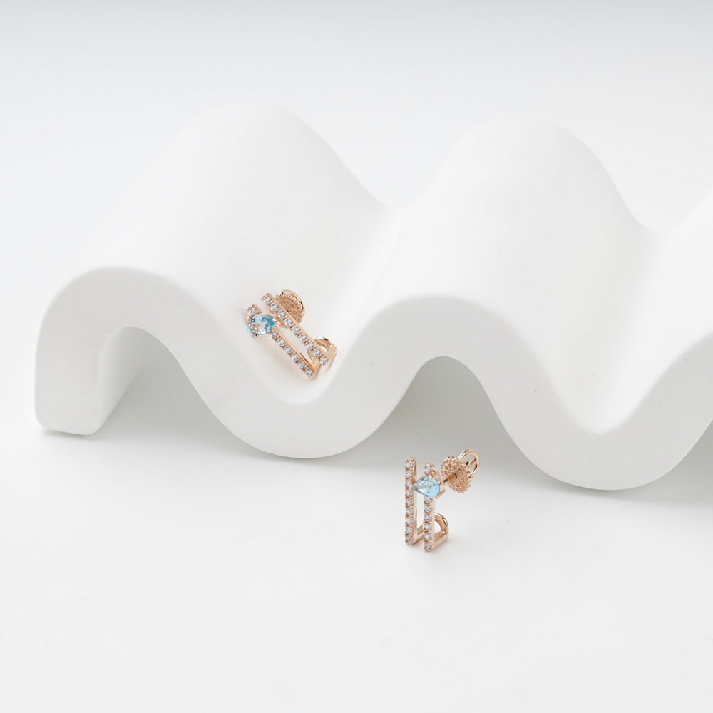 Geometric Stud Earrings with Blue Topaz | 14K Rose Gold (585) — angled view