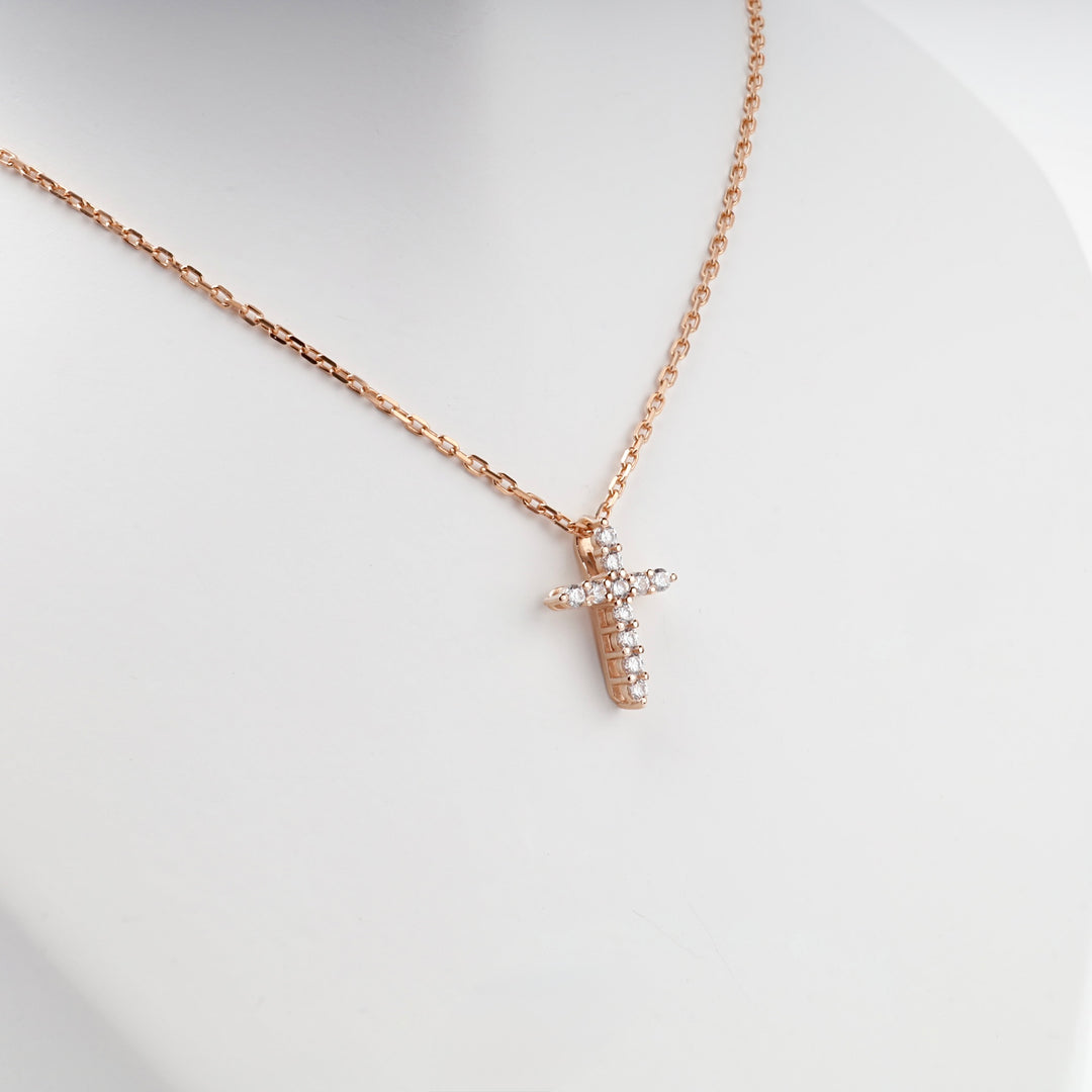 Petite 14K rose gold CZ cross pendant, close view