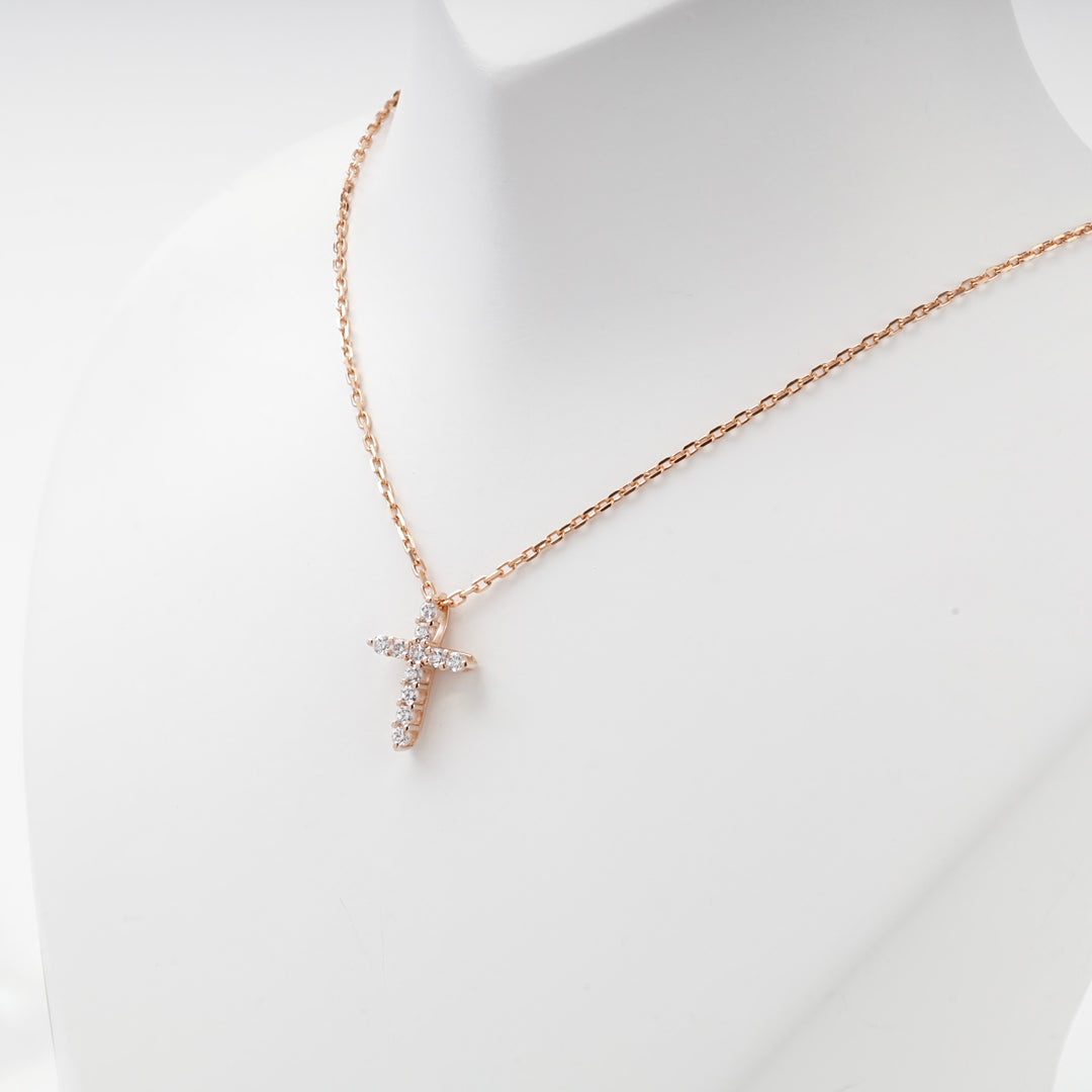 Small rose gold cross pendant set with cubic zirconia, detail