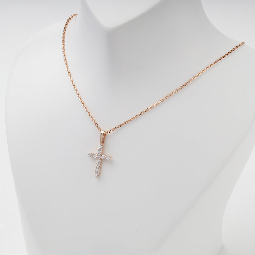 Prong-set rose gold cubic zirconia cross pendant, angled view