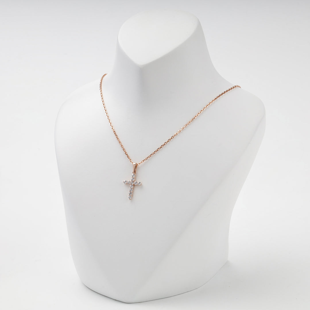 Rose gold cross pendant with cubic zirconia, studio view