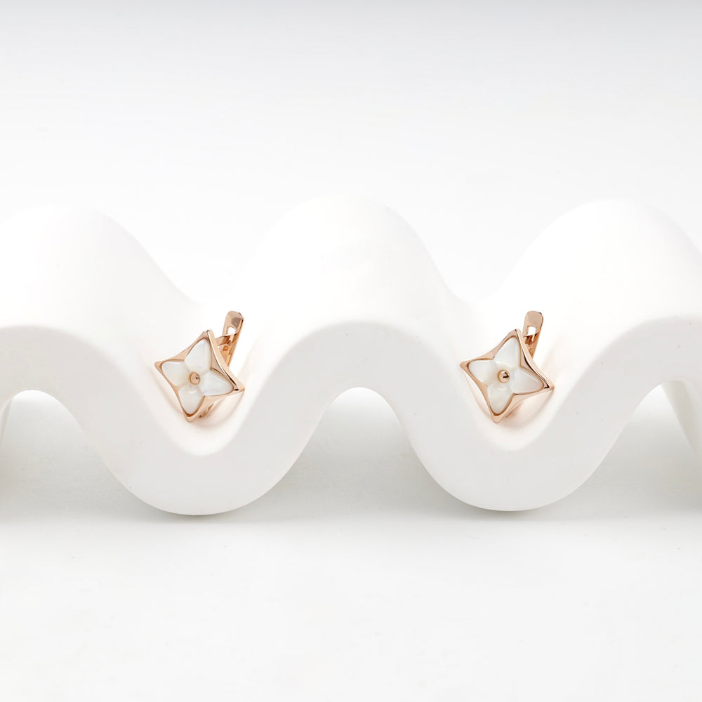 Rose gold star earrings mother of pearl close-up