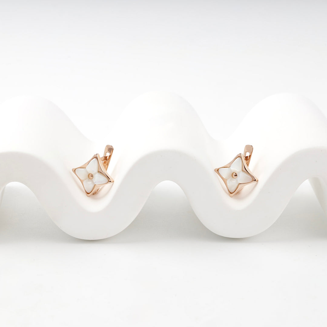 Rose gold star earrings mother of pearl close-up