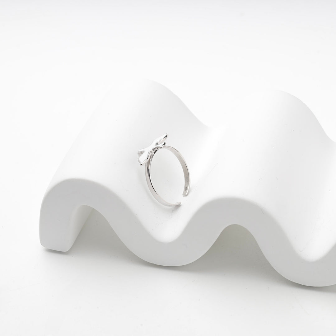 Bird ring resting on a white wave display