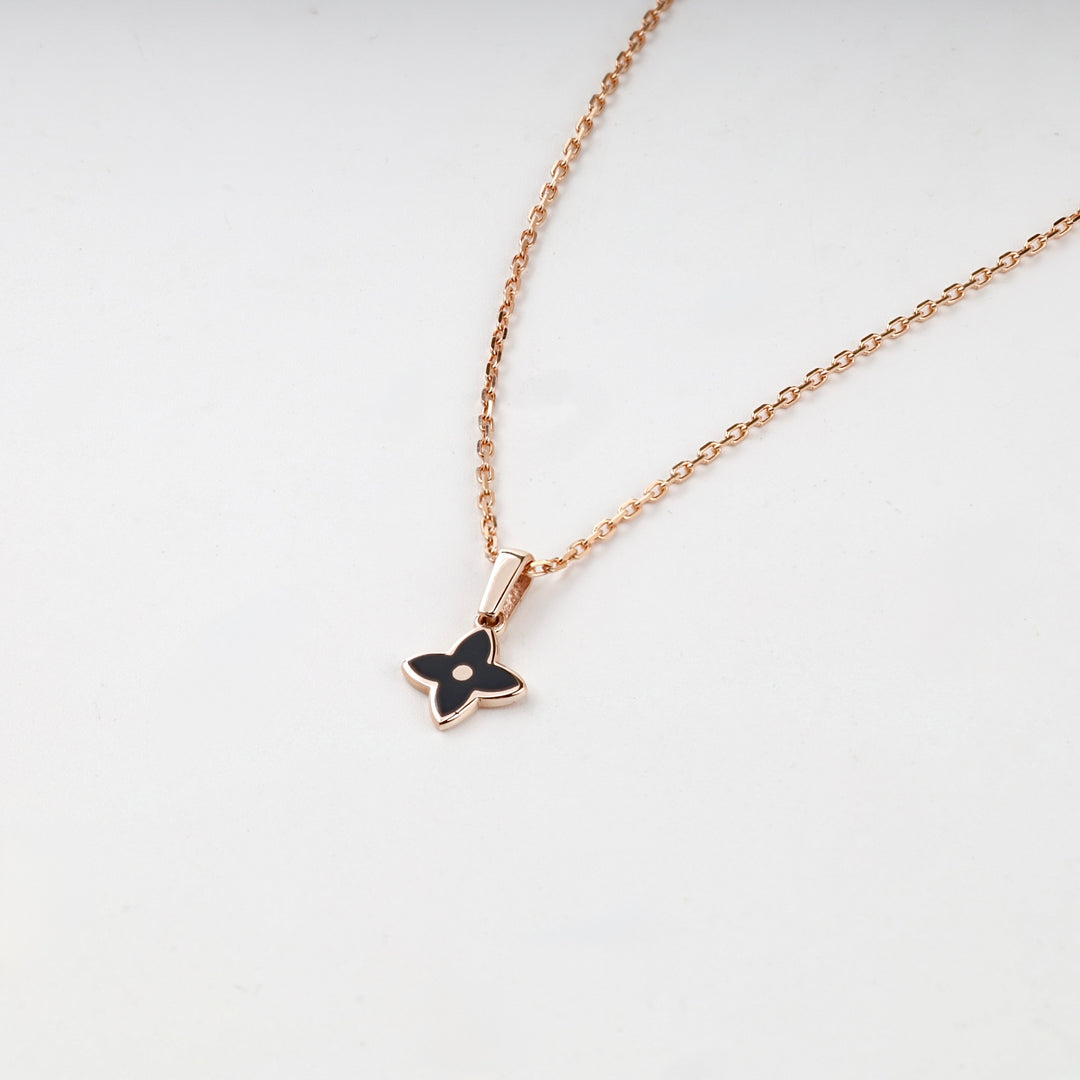 Rose gold black flower pendant close-up