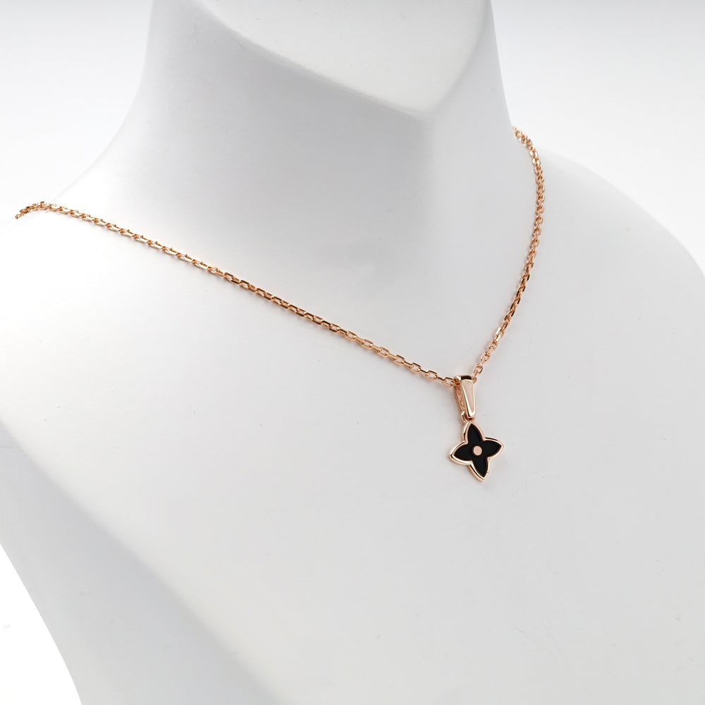 Rose gold black enamel pendant on white background