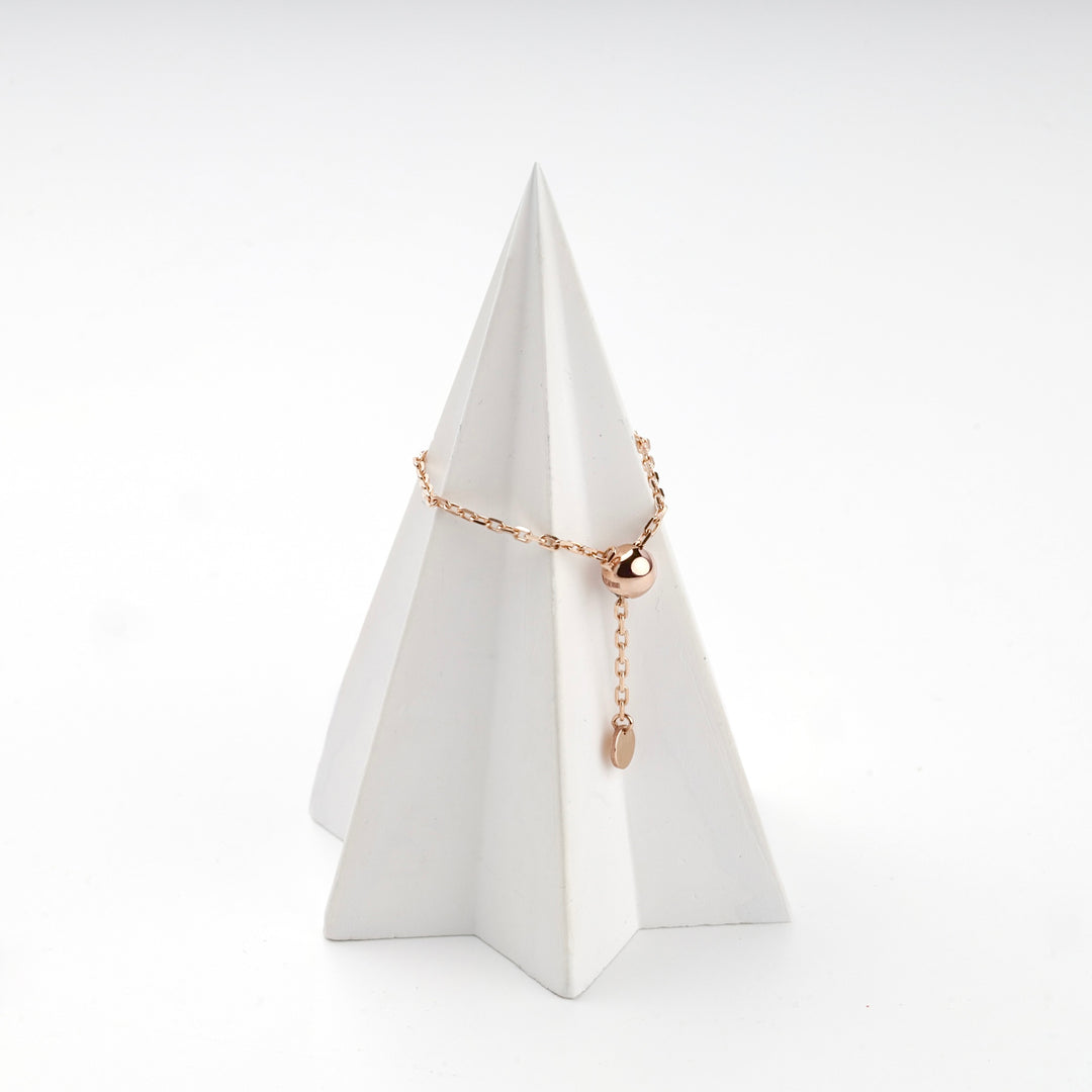 Rose gold ball chain ring on a white display cone with the disc charm hanging free