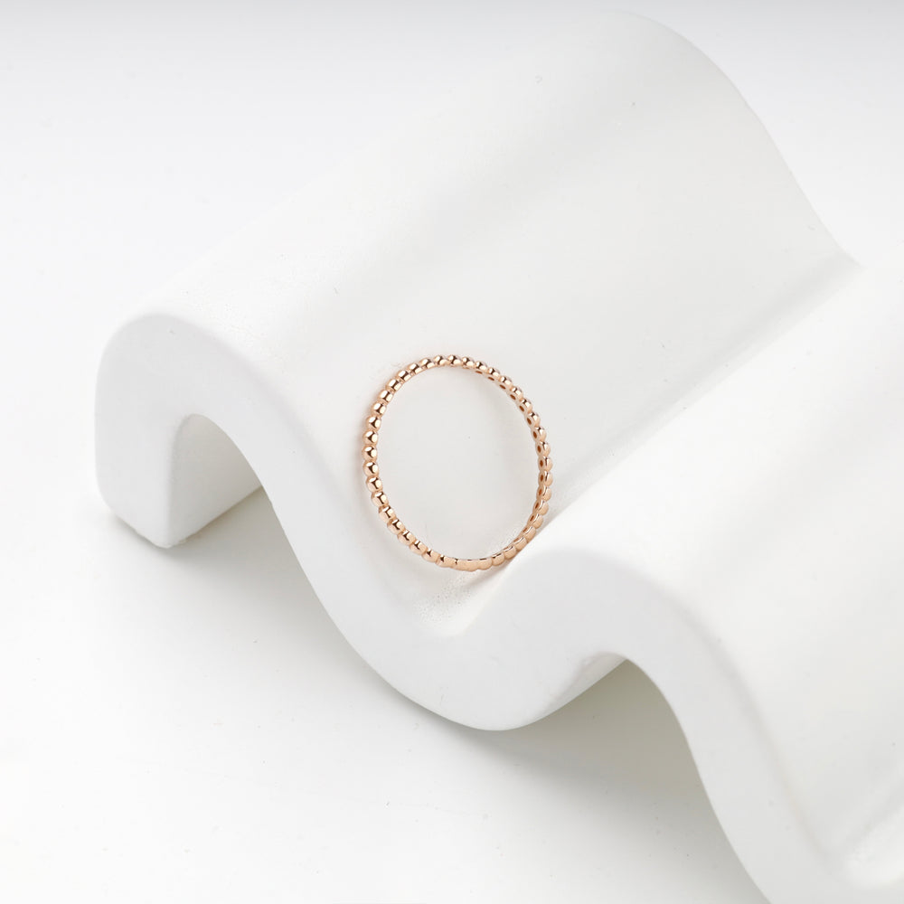 Close view of the rose gold ring showing the continuous row of round beads
