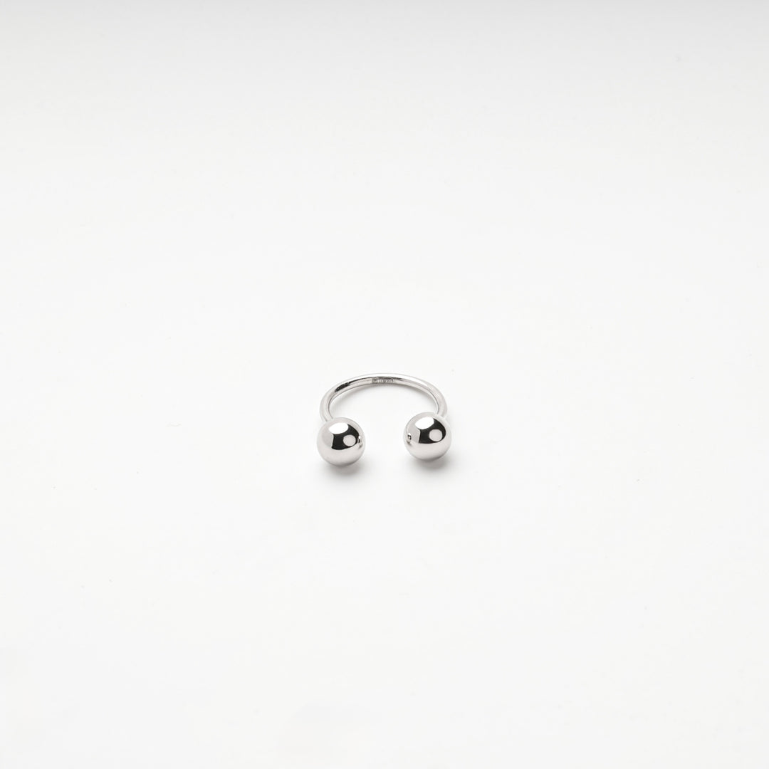 Front view of the silver 925 open ring with the two balls facing each other
