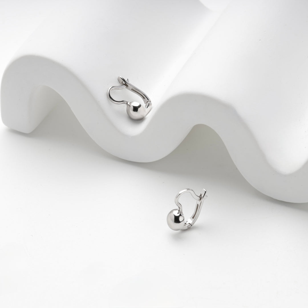 Silver 925 ball leverback earrings on a white wave stand