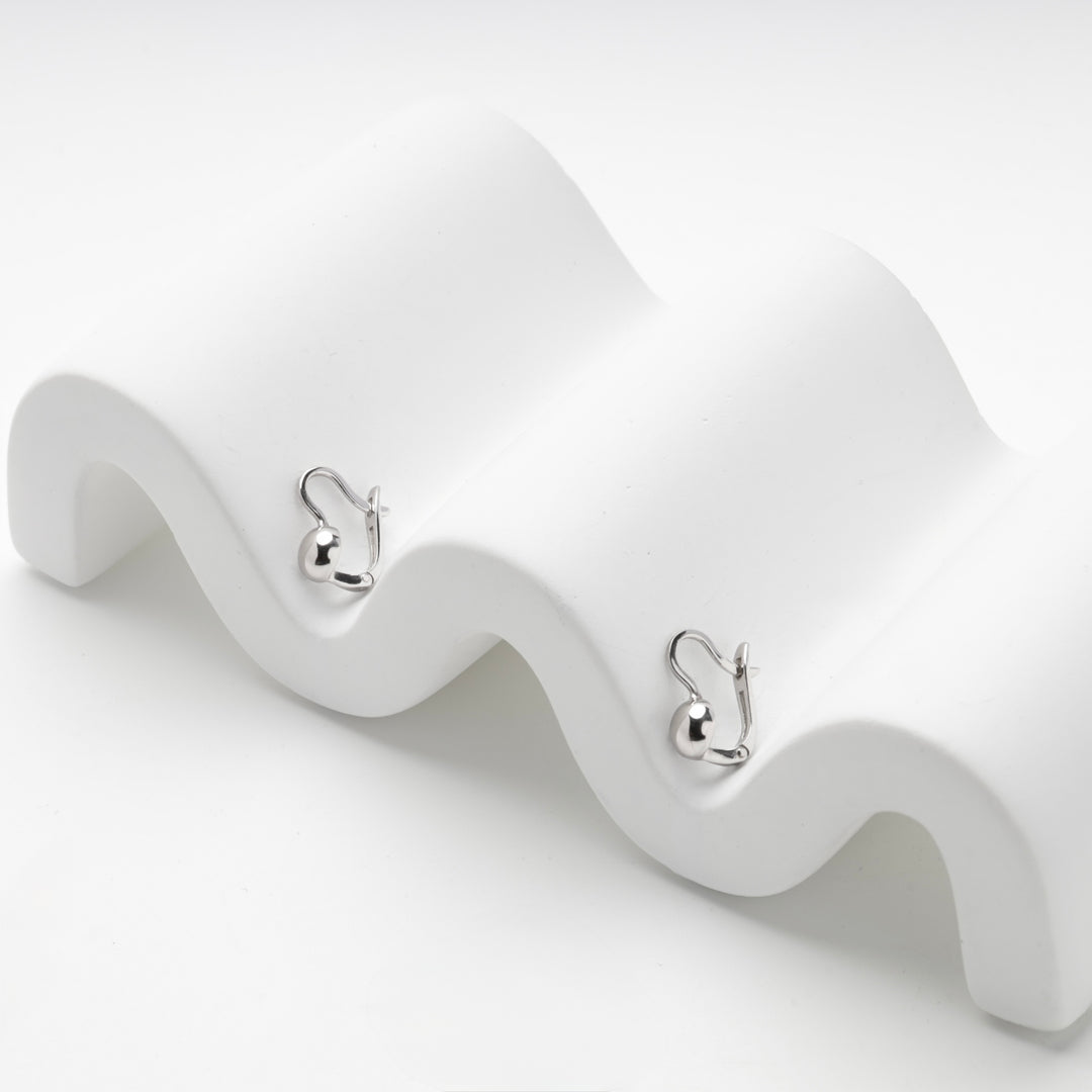 Angled view of the silver 925 ball leverback earrings