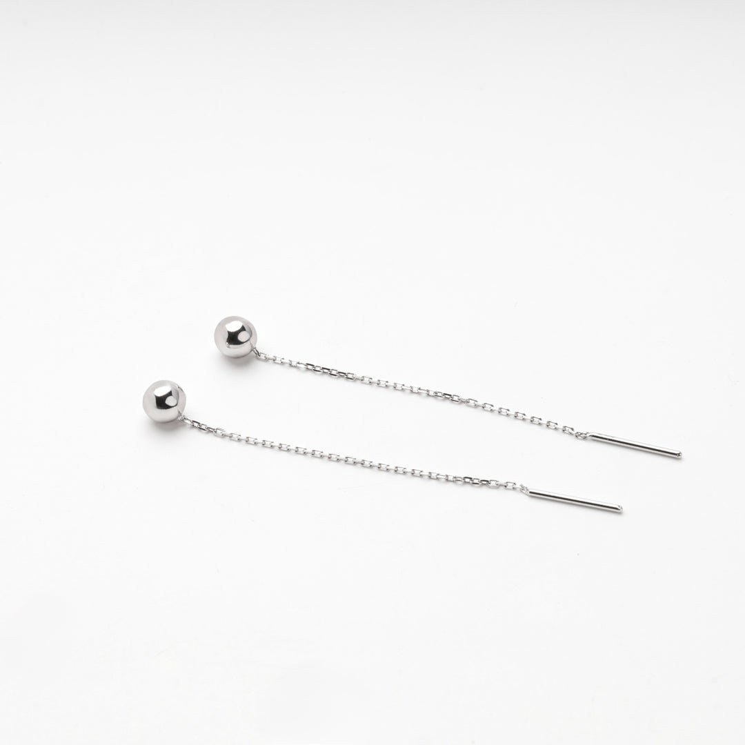 Pair of silver 925 ball threader earrings laid flat