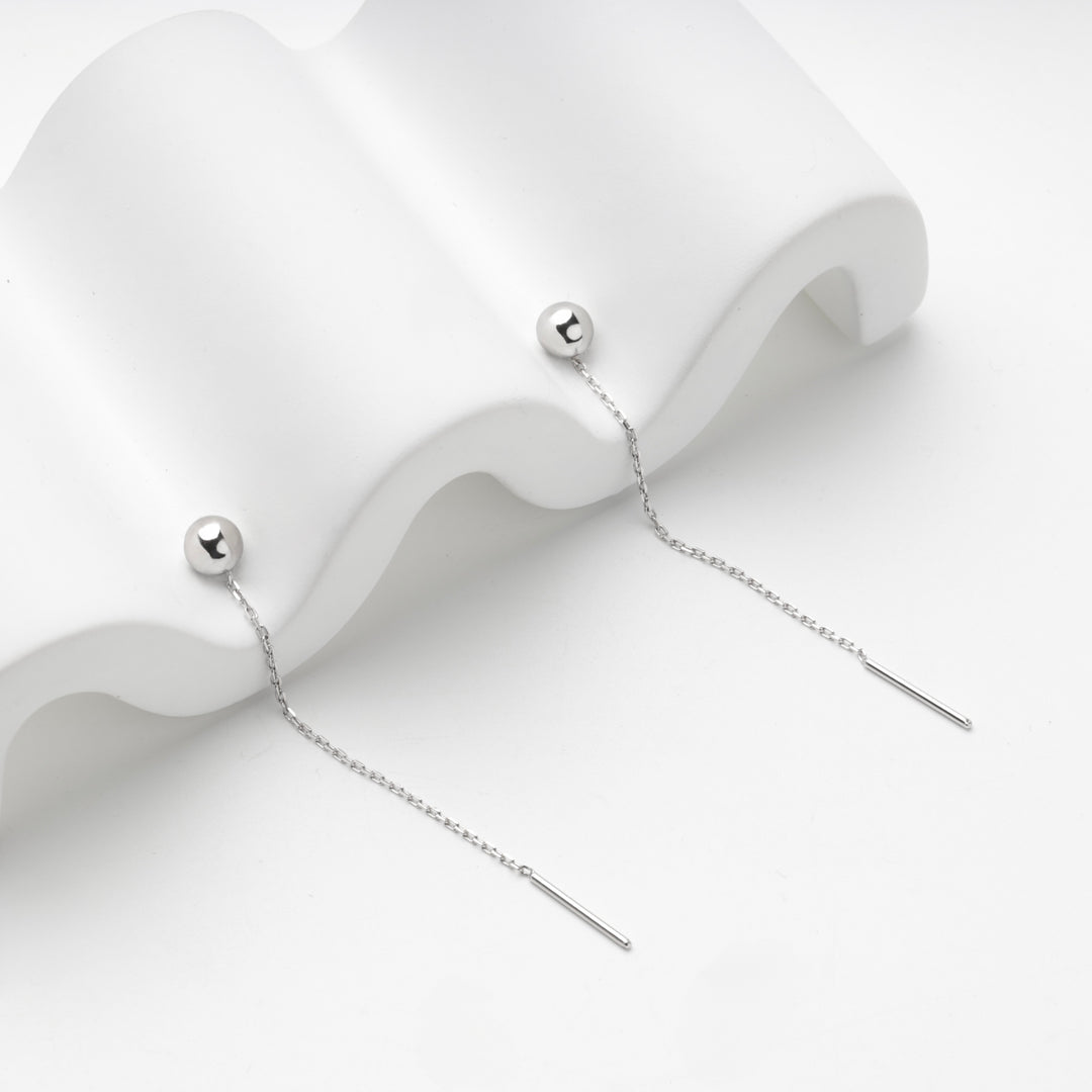 Close view of the polished ball and fine chain of the silver 925 threader earrings