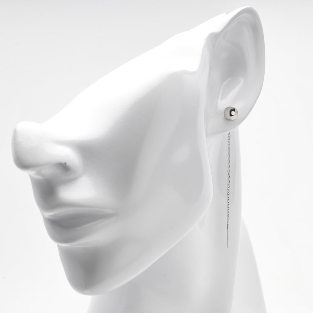 Profile view of the silver 925 threader earring falling behind the lobe