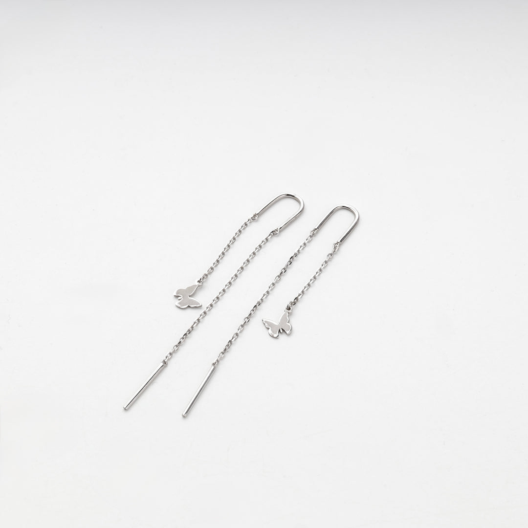 Pair of silver 925 butterfly threader earrings laid straight