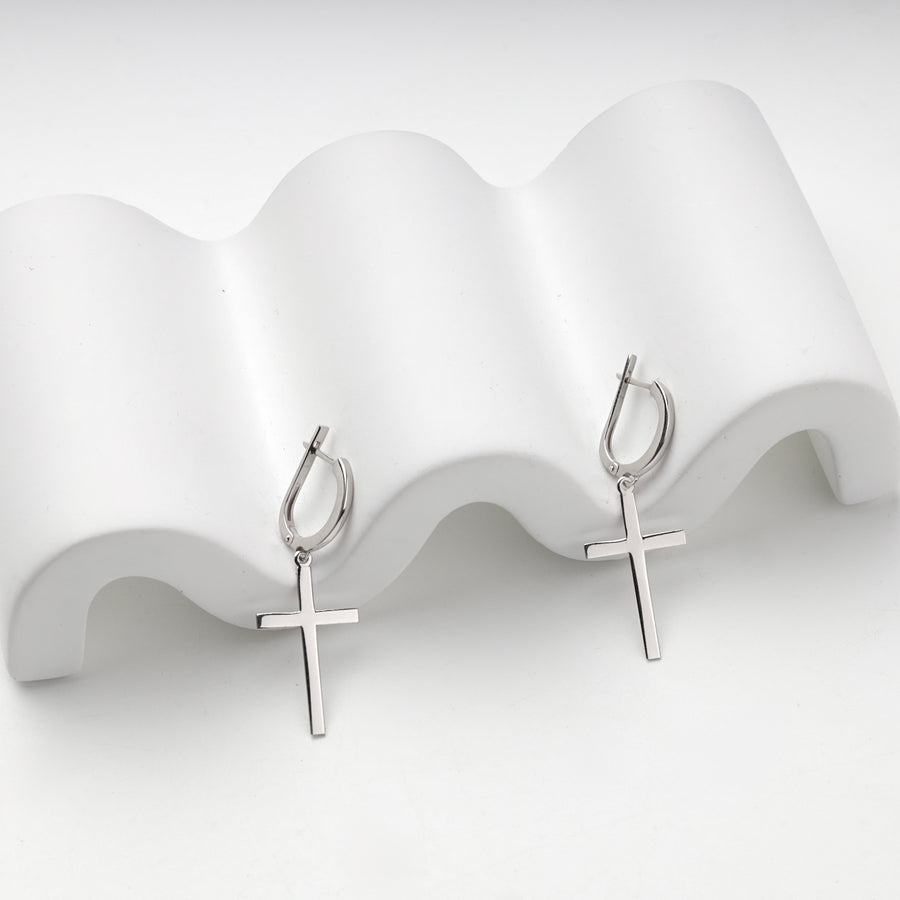 Silver 925 cross drop earrings on a wave stand, side angle