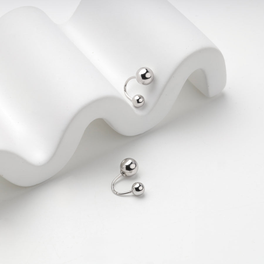 Silver 925 double ball earrings on a white wave stand