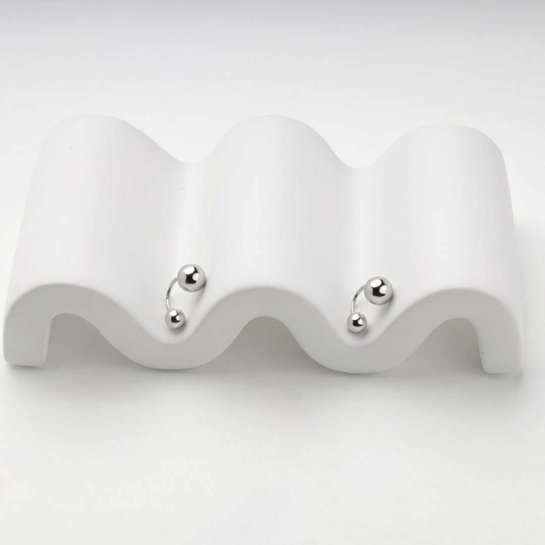 Silver 925 earrings with two polished balls, angled view