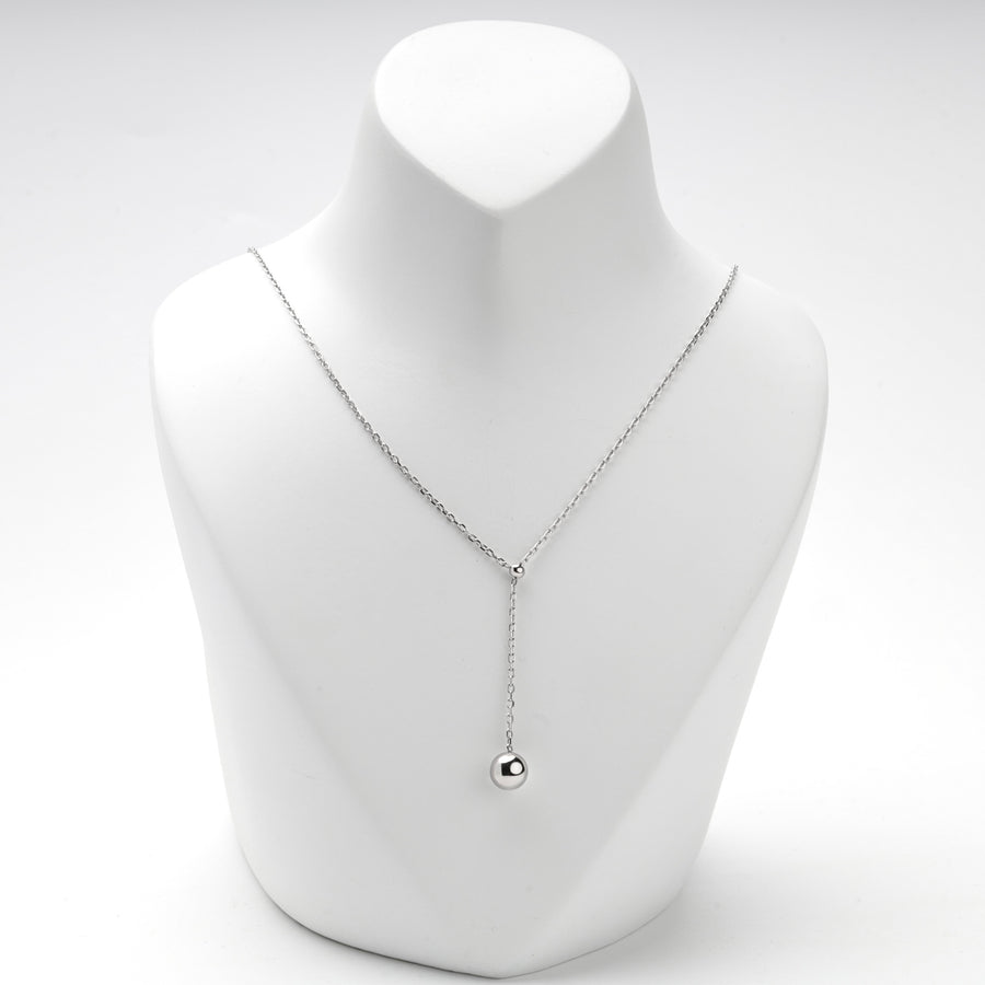 Front view of the silver ball drop necklace at a mid-length setting