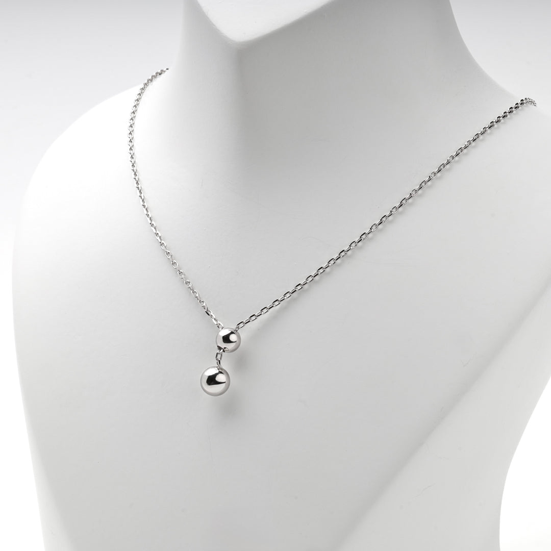 Silver 925 Y necklace with two polished balls on a display bust