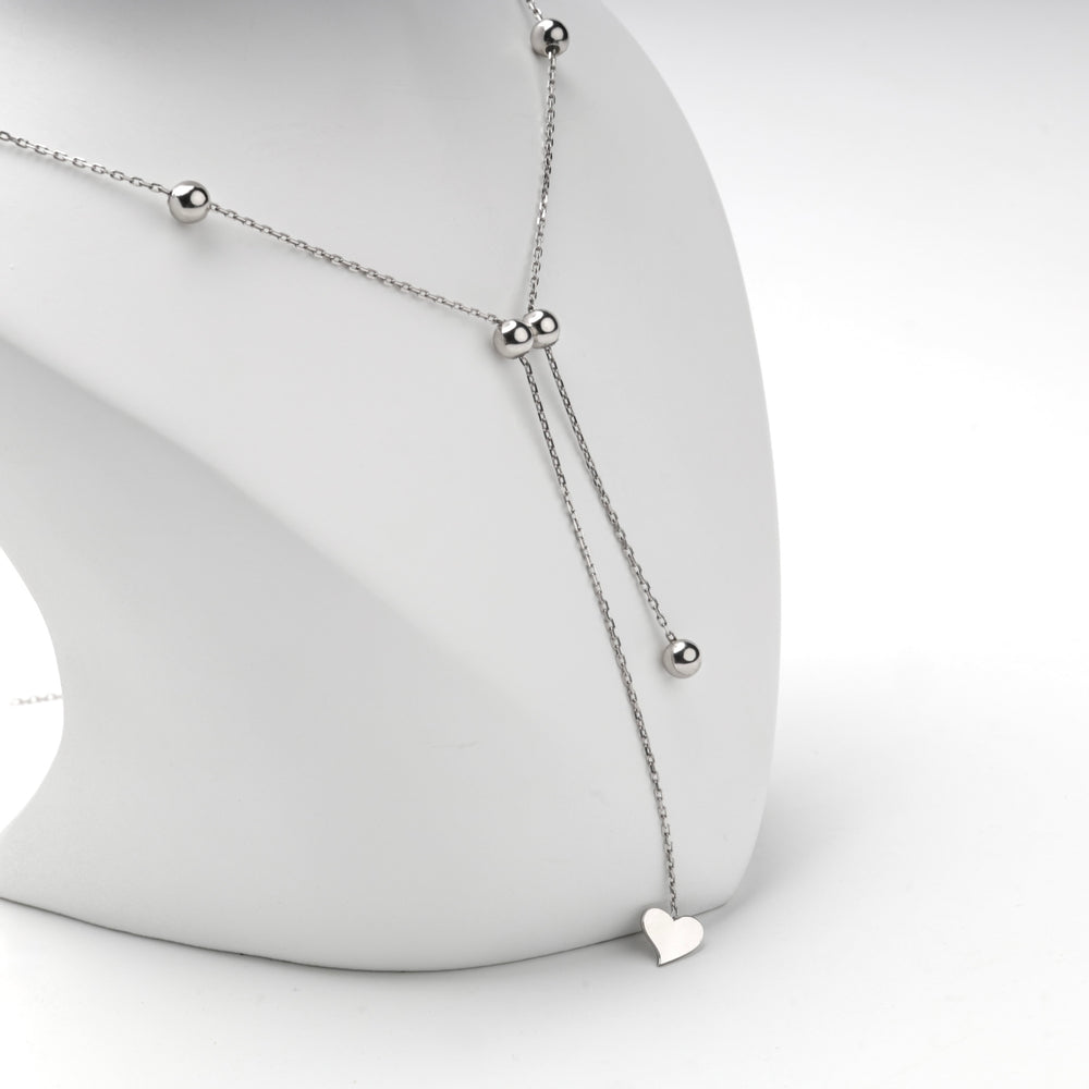 Silver 925 beaded Y necklace with a heart drop on a display bust