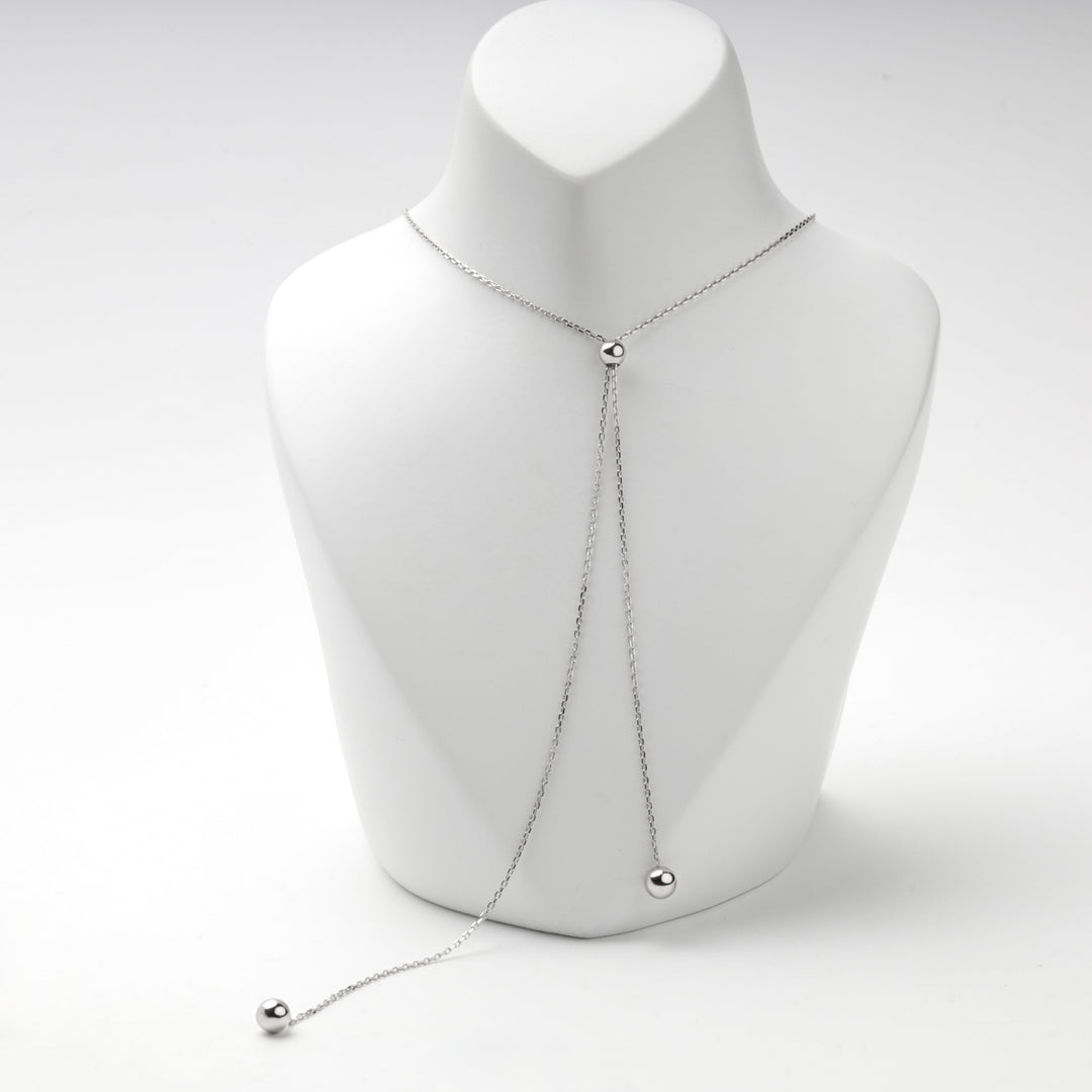 Bolo necklace on a white bust showing both ball tips