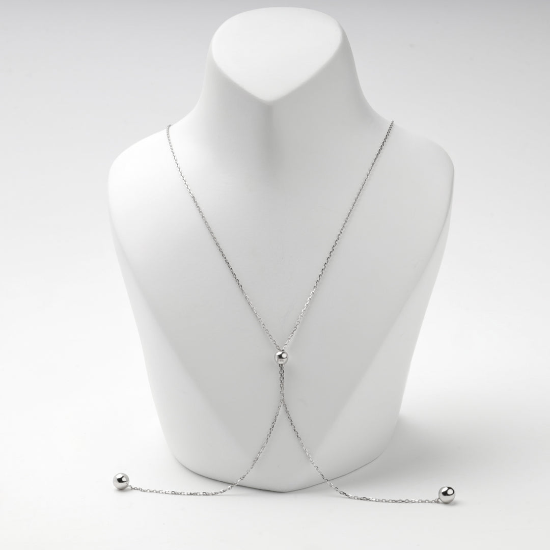 Chain of the bolo necklace drawn out with a polished ball at each end