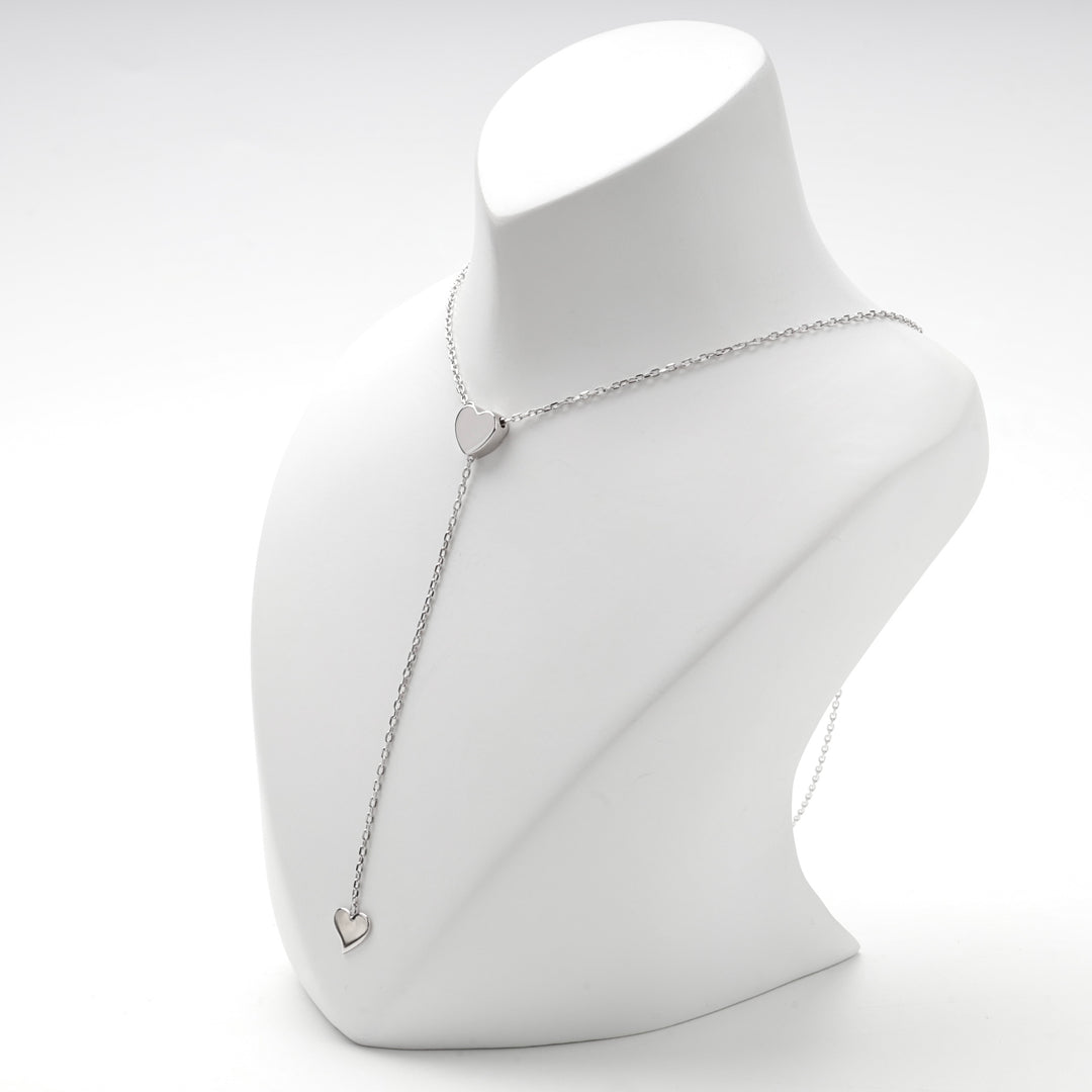 Angled view of the two heart Y necklace with the drop hanging to one side