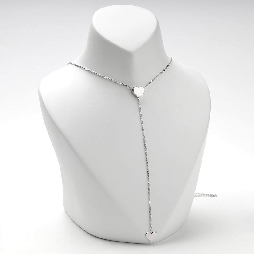 Two heart Y necklace worn at the base of the neck, front view