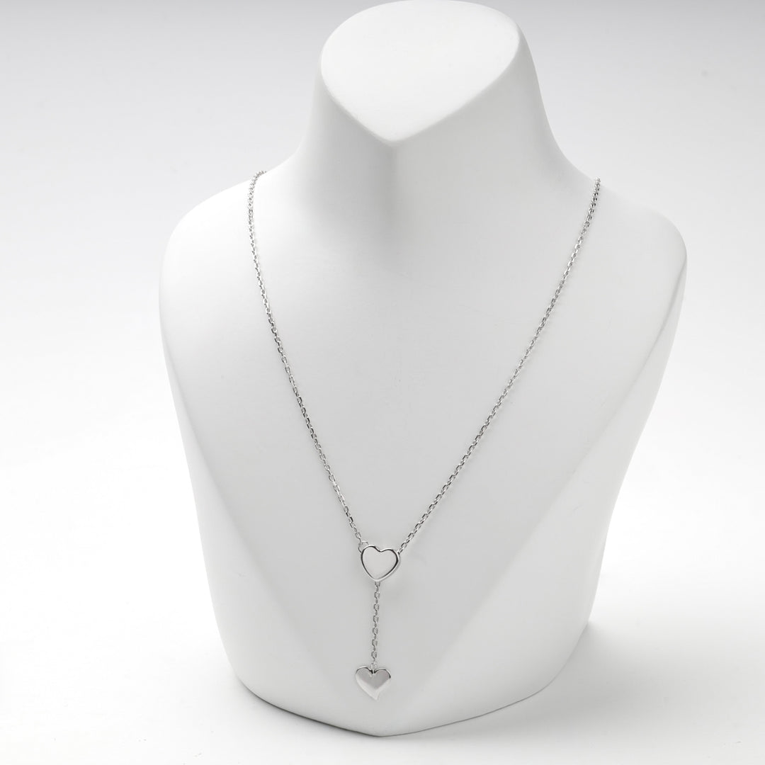 Y necklace with the lower heart hanging on a short chain drop
