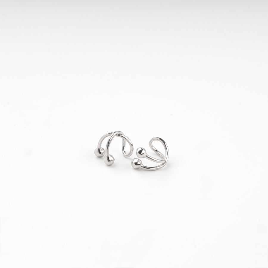 Pair of silver 925 crossover ear cuffs with polished ball ends