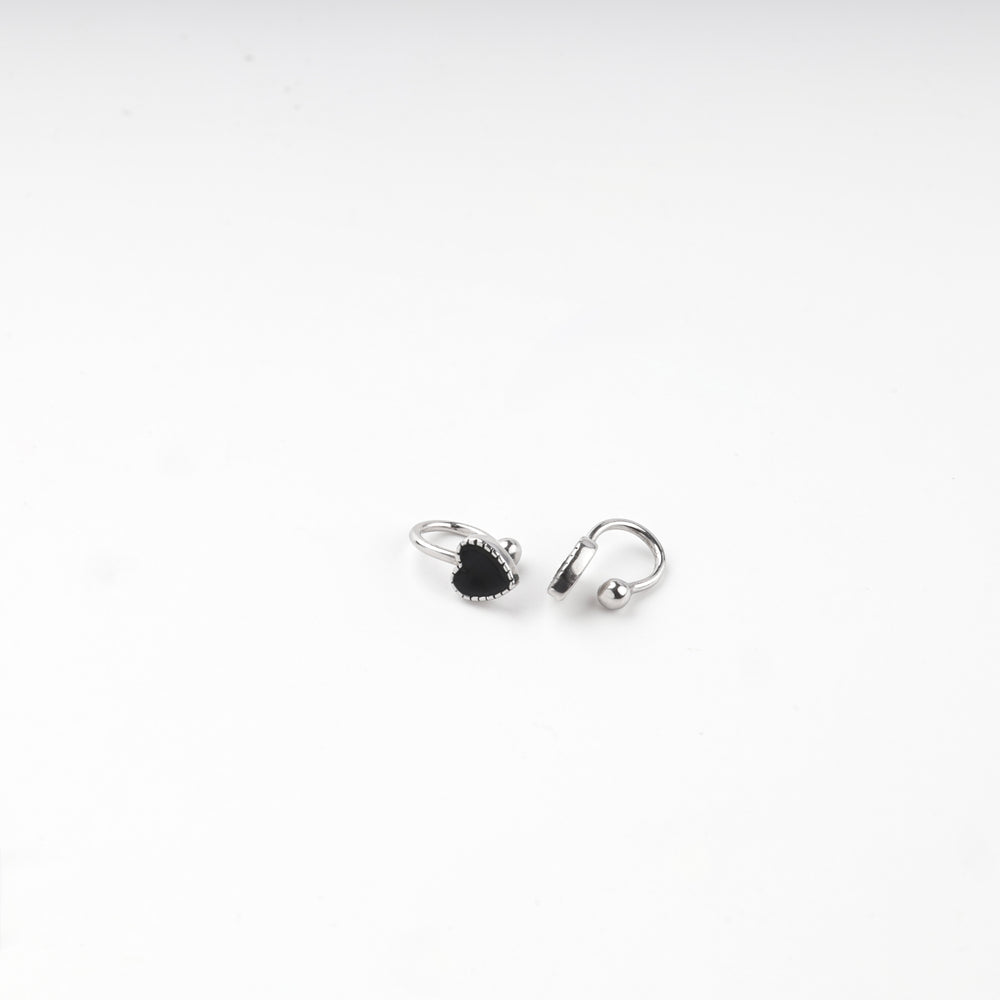 Pair of silver 925 black heart hoop earrings laid flat
