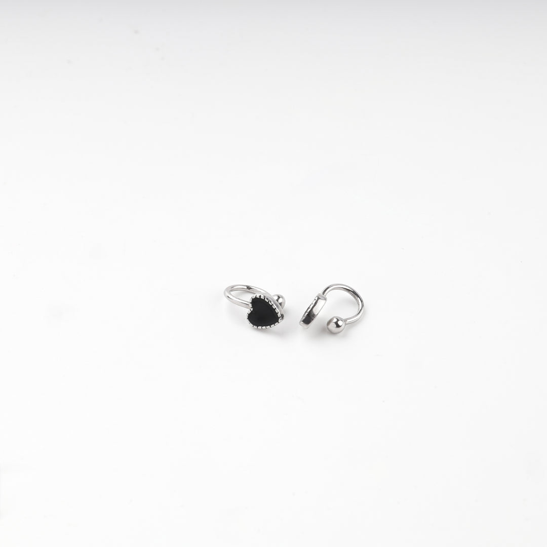 Pair of silver 925 black heart hoop earrings laid flat