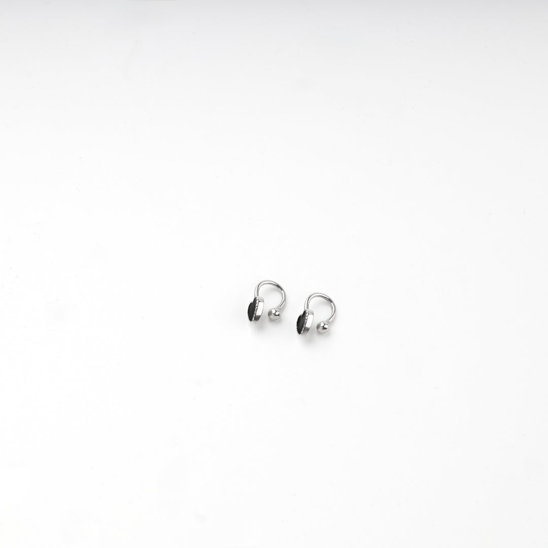 Close view of the black heart and polished ball on the silver 925 hoop earring