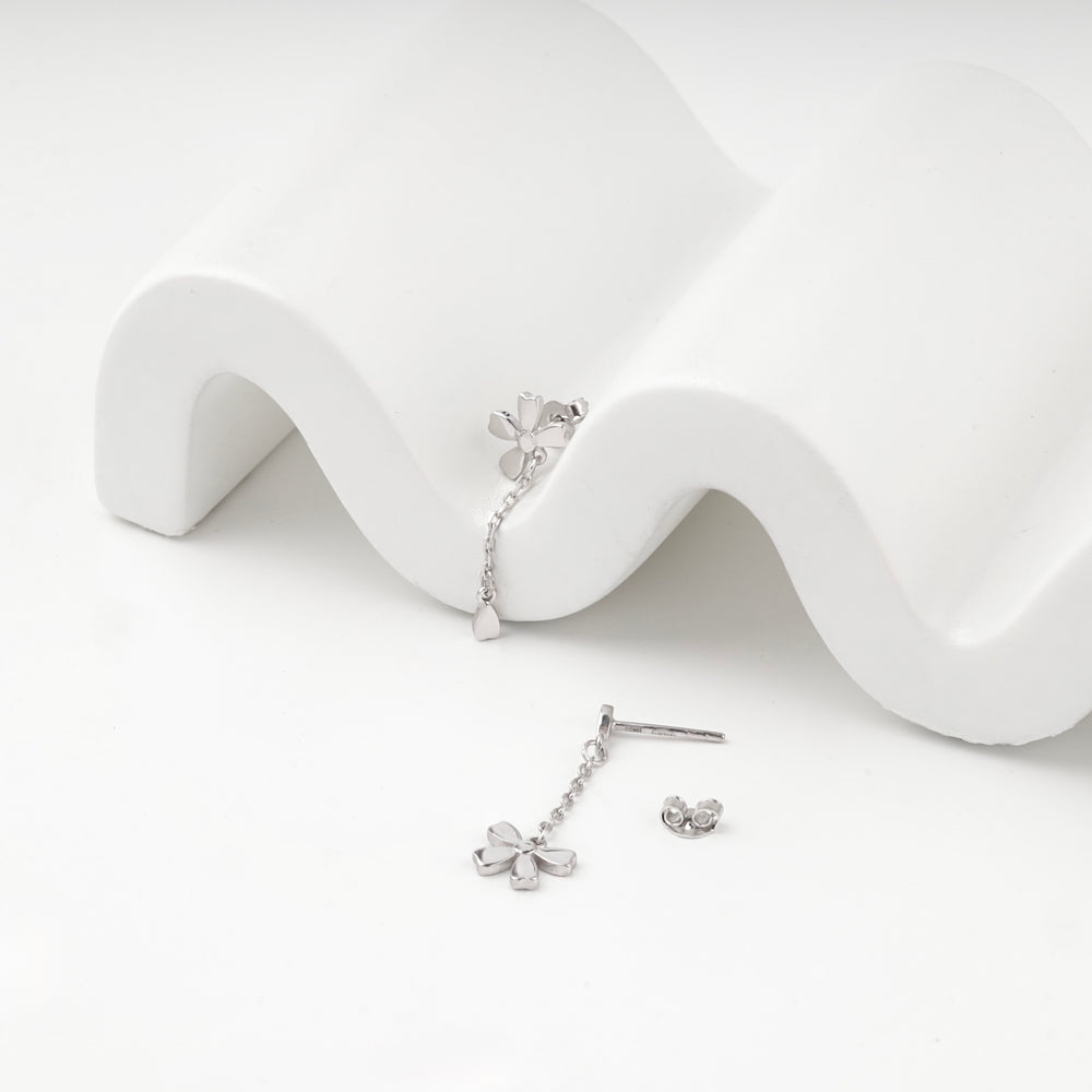 Silver 925 flower earrings with a chain drop, angled view