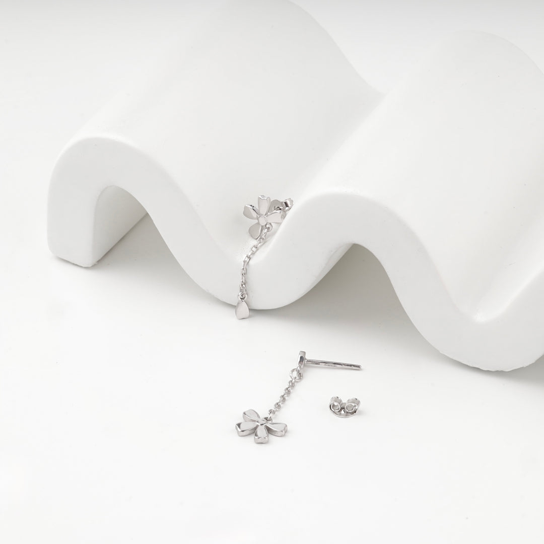 Silver 925 flower earrings with a chain drop, angled view