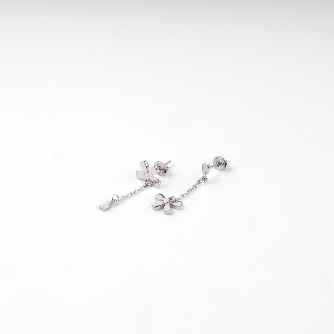 Pair of silver 925 flower drop stud earrings laid flat