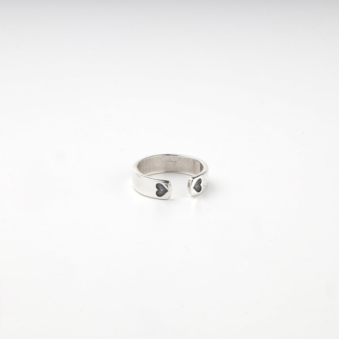 Silver ring turned to show the blackened hearts on the band