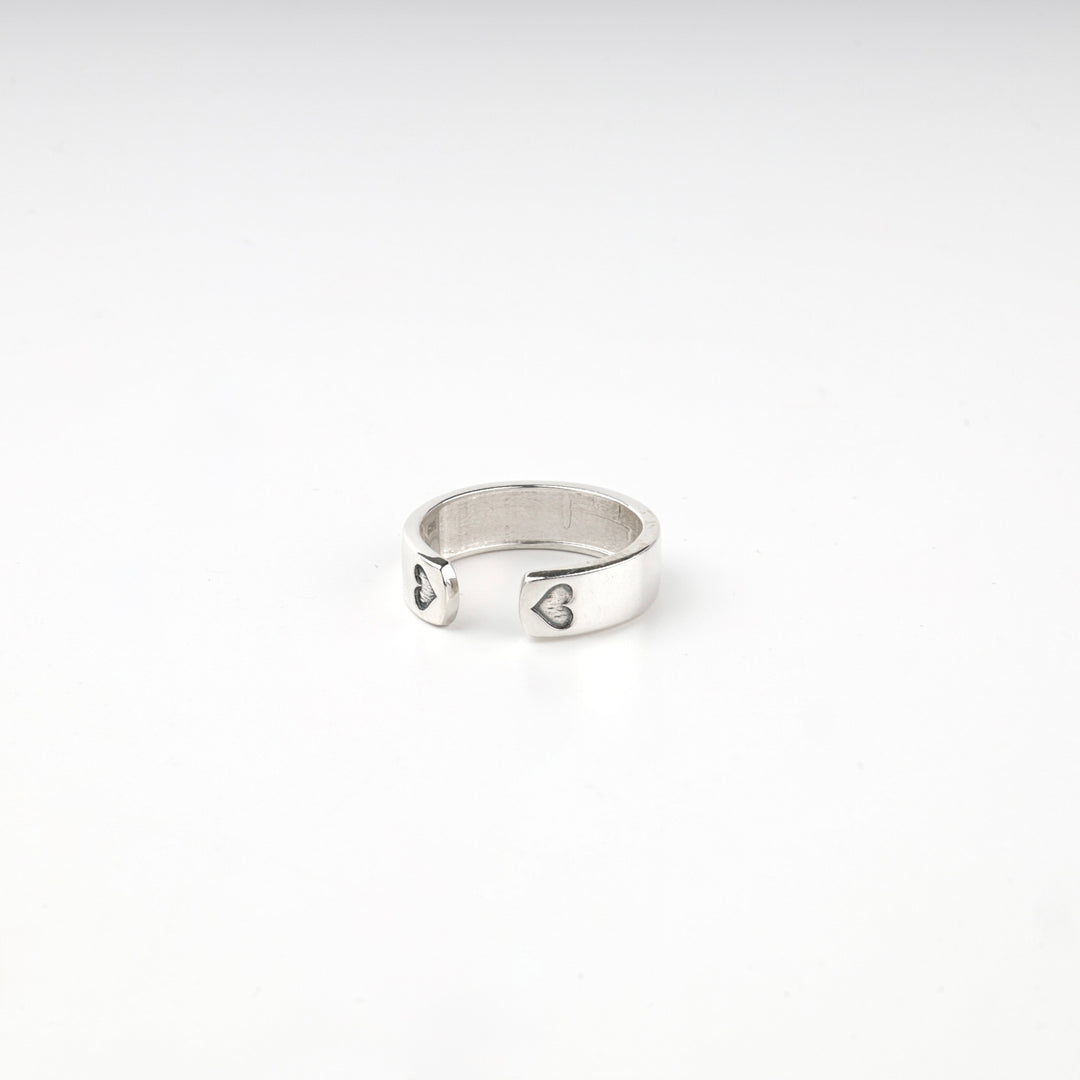 Silver ring turned to show the blackened hearts at the opening